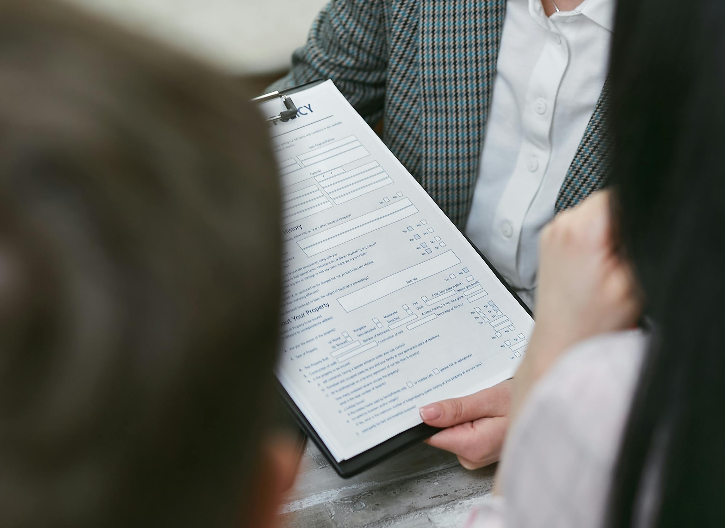 Close-up of professionals discussing a legal contract during a business meeting.